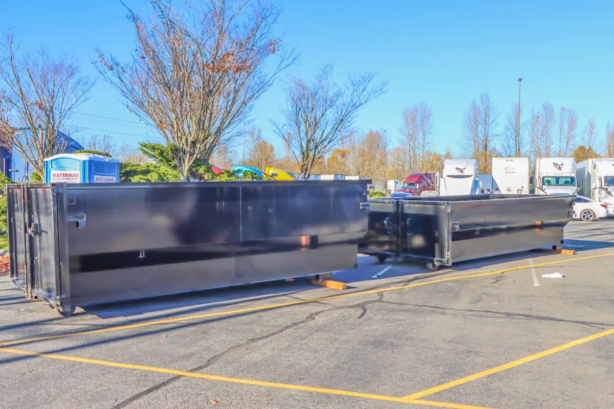 Professional dumpster rental service with roll-off container on residential driveway in Coeymans